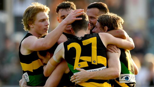 Dromana players, including the retiring Terry Wheeler (No.27), celebrate their 2023 premiership. (Photo by Josh Chadwick)