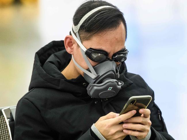 A passenger in goggles and a face mask at Hong Kong’s main high speed rail station connecting to mainland China. Picture: AFP