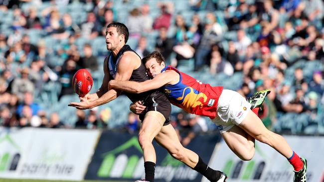 Travis Boak gets caught by then Lion Sam Docherty. Picture: Sarah Reed