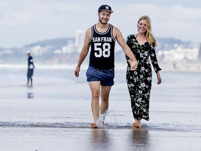 ## ON HOLD - SEE GCB FOR USE ##German tourists Julian Sipos, 24, and Hannah Dollriess, 22, walking along Surfers Paradise beach. Photos for tourism  numbers. Picture: Jerad Williams