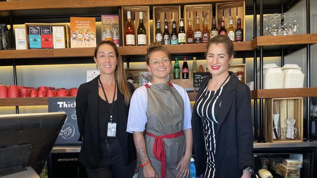 Macchinetta duty manager Rachel Jones, barista Fanni Van Osselaer and Sun Airport Hospitality operations manager Amy Glennon are ready to see domestic travellers again. Picture: Andreas Nicola