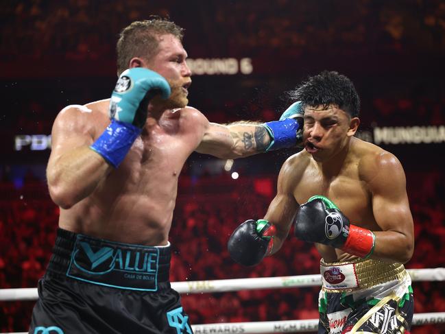 LAS VEGAS, NEVADA - MAY 04: Canelo Alvarez lands a left against Jaime Munguia in their super middleweight championship title fight at T-Mobile Arena on May 04, 2024 in Las Vegas, Nevada. (Photo by Christian Petersen/Getty Images)