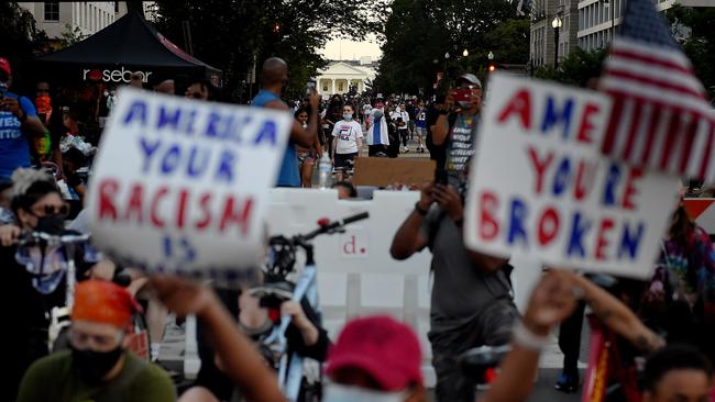 Demonstrators kneel as they protest against police brutality and the death of George Floyd, across from the White House. Picture: AFP