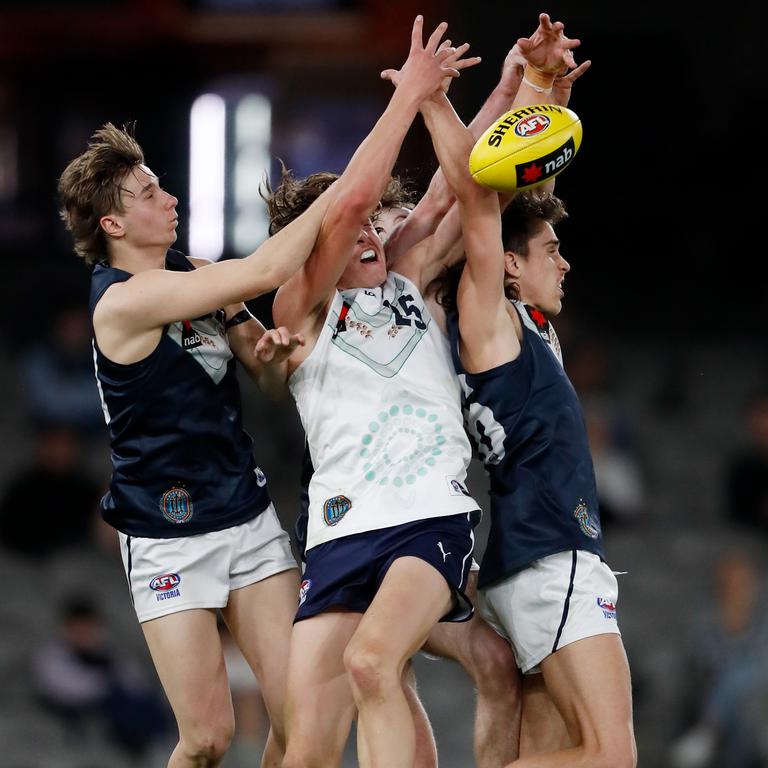 Aaron Cadman (centre) flies for a mark during the National Championships.