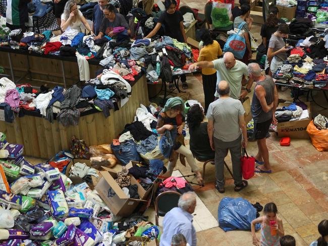 Israeli evacuees from Kibbutzim near the Gaza border receive clothing donations at a hotel. Picture: Gil Cohen-Magen/AFP