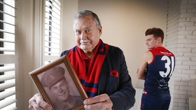 Barassi with a photo of his father Ron Sr. in military uniform. Picture: David Caird