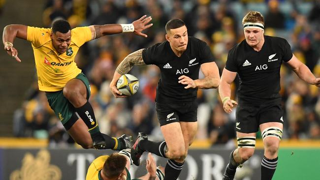 Sonny Bill Williams of New Zealand steps through a tackle by Sean McMahon of Australia.