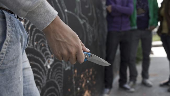 Adolescent threatening a group with a knife. Photo: File.