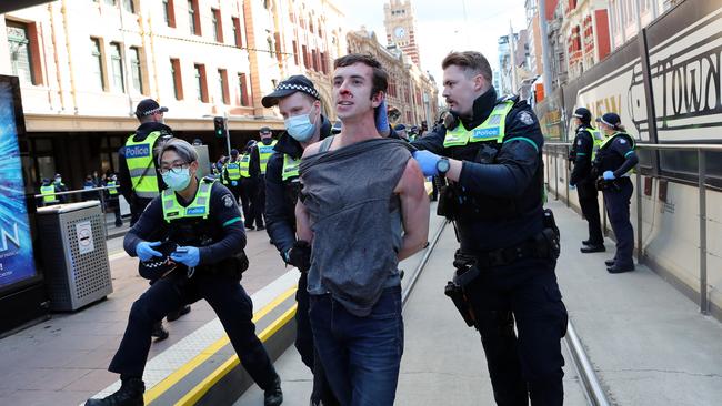 A man at the rally in police custody. Picture: Rebecca Michael