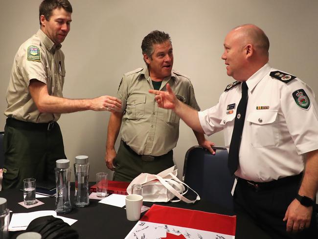 RFS Commissioner Shane Fitzsimmons shakes hands with Canadian and US firefighters during a farewell today. Picture: AAP