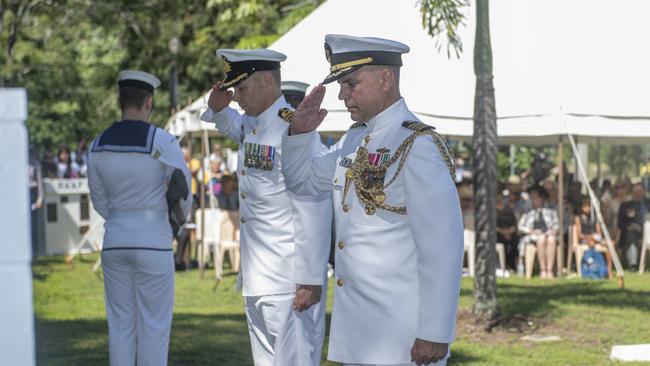 Commander David Hannah from HMAS Cairns and US naval attache, Commander Tony De Frias, salute after laying wreaths at the 77th anniversary commemorations of the Battle of the Coral Sea at Cardwell yesterday. PIC: CHRIS HOLMES