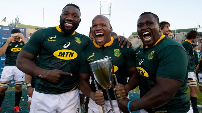 South Africans Tendai Mtawarira, left, Bongi Mbonambi and Trevor Nyakane with the Rugby Championship trophy last year