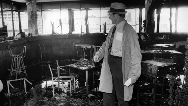 Inspector Les Bardwell of the Queensland Police Scientific Section inspects the devastated interior of the Whiskey Au Go Go nightclub. Picture: News Limited