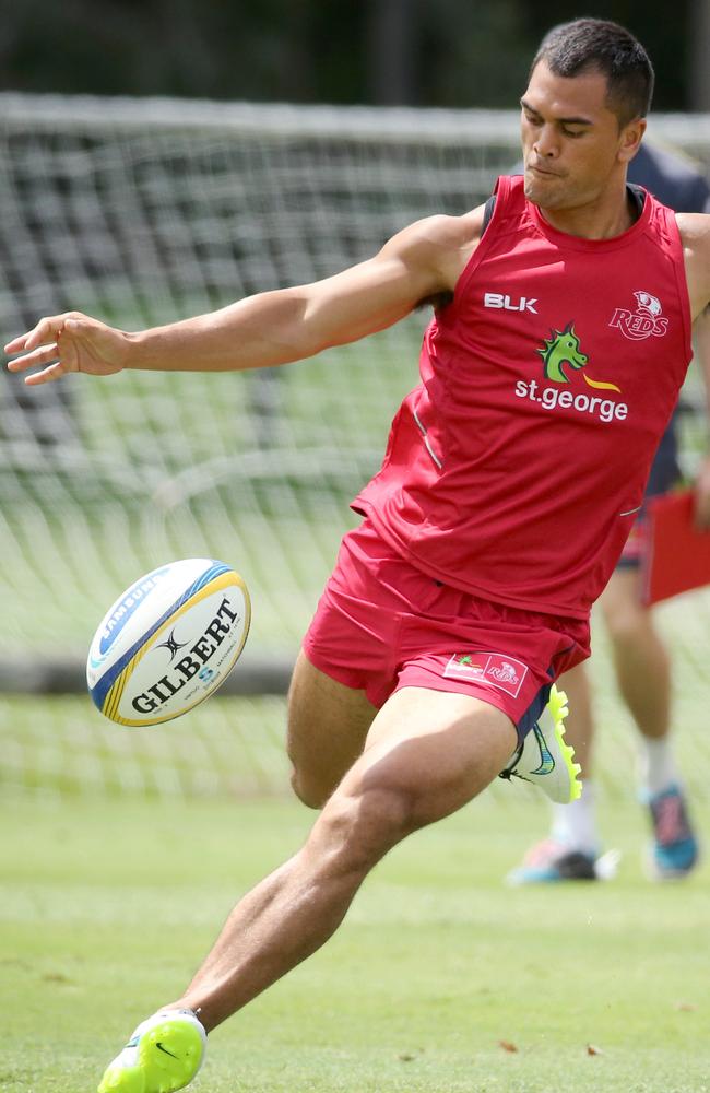 Karmichael Hunt sends the ball downfield during the Reds hit-out at Ballymore.