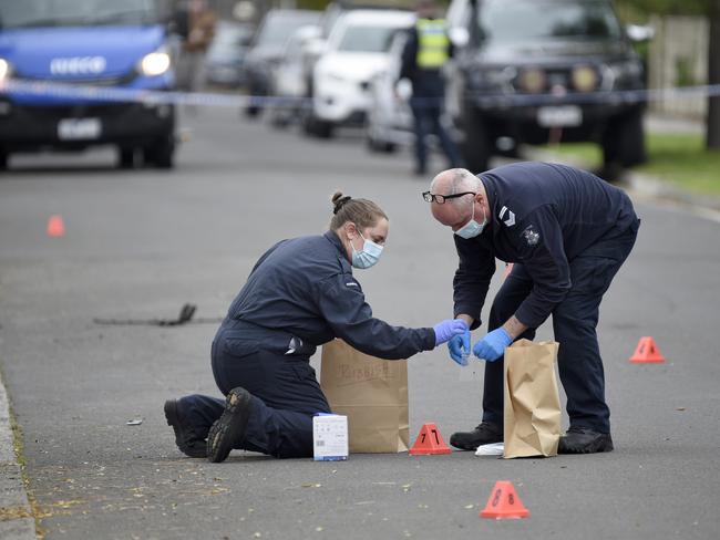 Detectives collect evidence from the road outside Abdulrahim’s home. Picture: Andrew Henshaw