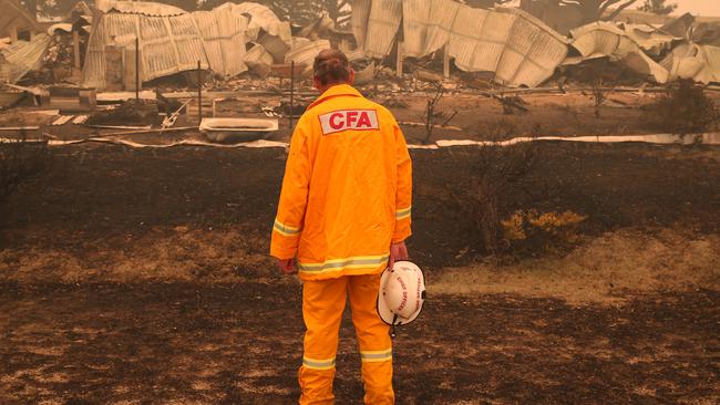 Outgoing CFA fire chief Steve Warrington inspects the remains of a Buchan home destroyed in this summer’s bushfires. Picture: News Corp