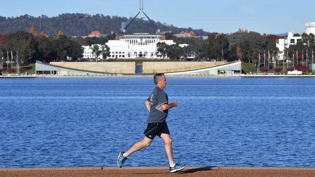 Opposition Leader Bill Shorten runs past Old Parliament House in Canberra. Picture: AAP