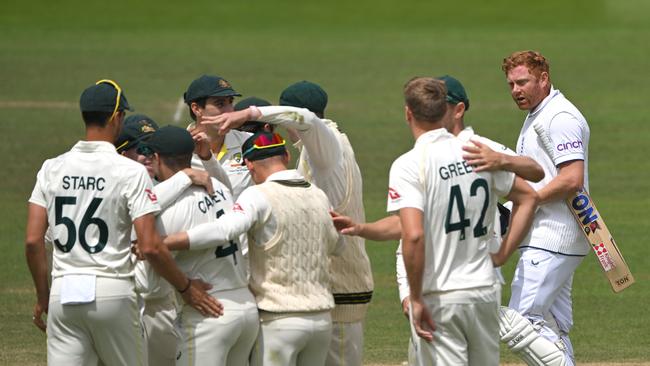 England batsman Jonny Bairstow looks on as Australia fielders celebrate after being given run out.