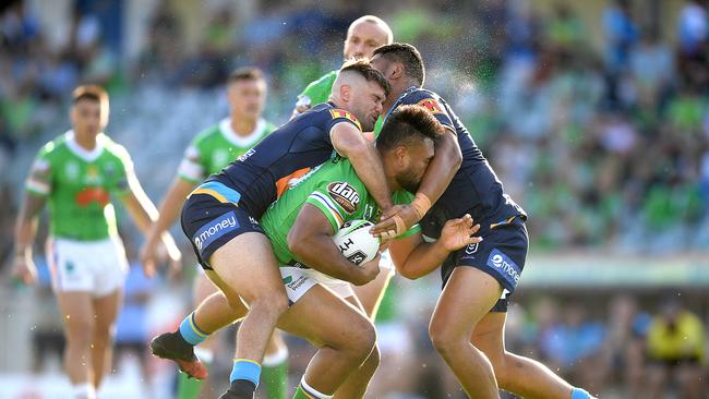 Mitch Rein of the Titans (left) tackles Dunamis Luises of the Raiders. Picture: AAP Image/Lukas Coch