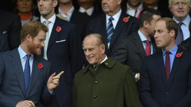 Prince Philip (C) and his grandson's Prince William (R) and Prince Harry (L) during the final match of the 2015 Rugby World Cup between New Zealand and Australia at Twickenham.