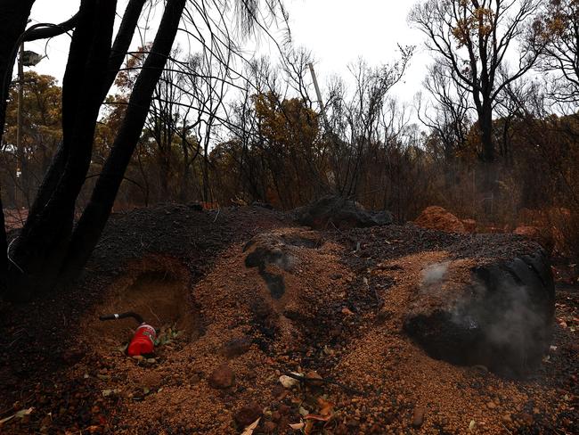 Smouldering bushland near Perth. Picture Paul Kane