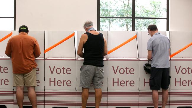 BRISBANE, AUSTRALIA - MARCH 28: Voters are seen keeping a distance at Brisbane City Hall on March 28, 2020 in Brisbane, Australia. Queensland local government elections and two state by-elections  are going ahead on Saturday, despite concerns about people gathering at polling stations amid the ongoing COVID-19 pandemic. Authorities will be imposing social distancing measures, and with a record number of pre-poll and postal votes, believe the risk of spreading the coronavirus is low compared to other day-to-day activities like visiting the supermarket. The Federal Government has introduced strict measures in response to the COVID-19 outbreak, requiring Australians to practise social distancing when outside their homes, banning large indoor and outdoor gatherings and limiting international and domestic travel to essential, work-related or compassionate only. All libraries, museums, galleries, beauty salons, tattoo parlours, shopping centre food courts, auctions, open houses, amusement parks, arcades, indoor and outdoor play centres, swimming pools are closed and indoor exercise activities are now banned along with bars, pubs, casinos and nightclubs. Restaurants and cafes are restricted to providing takeaway only. Weddings are now restricted to five people including the couple while funerals are limited to 10 mourners. All Australians are now expected to stay at home except for essential outings such as work, grocery shopping and medical appointments. Exercising outdoors alone is still permitted. Australia is approaching 3000 confirmed cases of COVID-19 while the death toll now stands at 13. (Photo by Jono Searle/Getty Images)