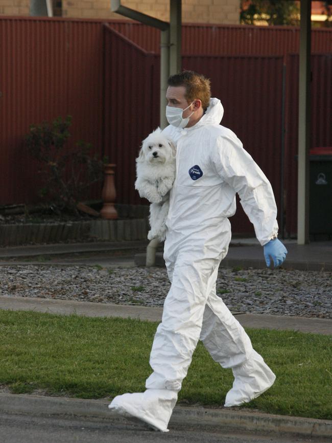 Forensics remove a dog from the home of Beverley Hanley.