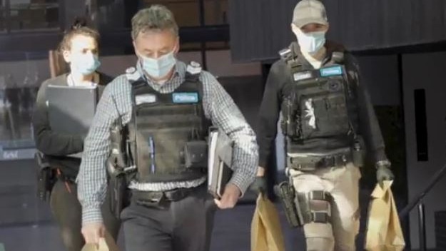 Detectives from a Southern Metro Divisional Response Unit at the scene of the raid in Melbourne’s southeastern suburbs.