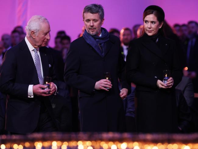 OSWIECIM, POLAND - JANUARY 27: (L-R) King Charles III and King Frederik X of Denmark and Queen Mary of Denmark wait to place a lit candle as tribute is paid to the Holocaust victims during the ceremony for the 80th anniversary of the liberation of the Auschwitz camp on January 27, 2025 in Oswiecim, Poland. The Nazis built and operated the Auschwitz complex of concentration camps during World War II initially for slave labor and later for the mass extermination of Jews and other undesirables. Approximately 1.1 million people died at Auschwitz, most of them in the notorious gas chambers of Auschwitz II-Birkenau. The Soviet Army liberated the camp in 1945. (Photo by Sean Gallup/Getty Images)