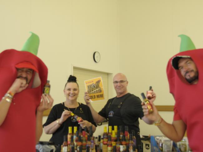 (From left) Chilli Carnival digital marketing manager Marco Sagona, Tania and Troy Simpson from Captain's Candy, and event co-director, Jason O'Connor showing off the awesome products available at Murphys Creek Chilli Carnival. Picture: Isabella Pesch