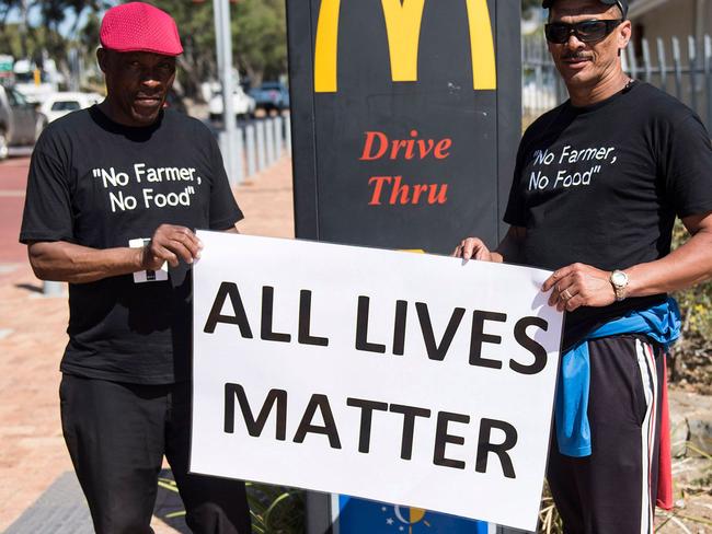 Protesters hold a banner  during a demonstration by South African farmers & farm workers  at the Green Point stadium to protest against farmer murders in the country, on October 30, 2017, in Cape Town. Thousands of white farmers blocked roads in South Africa on October 30 to protest against what they say is an explosion of violence against their communities in rural areas. Large demonstrations under the "Black Monday" banner were held in Cape Town, Johannesburg and the capital Pretoria. Marchers dressed in black to commemorate the victims of hundreds of deadly "farm attacks" in recent years. / AFP PHOTO / DAVID HARRISON