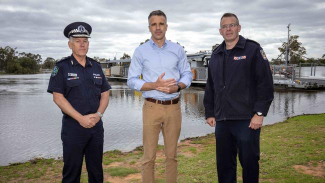 Police Commissioner Grant Stevens, Premier Peter Malinauskas and SES chief executive Chris Beattie at the Waikerie ferry, which will temporarily close on Wednesday. Picture: Emma Brasier