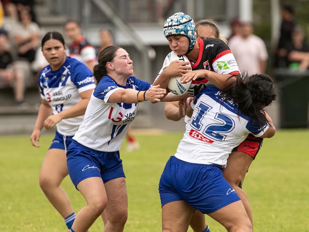 Brodie Pleasance is tackled by Lahnayah Daniel (right). Picture: Julian Andrews