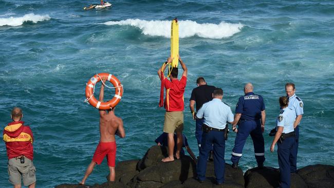 Police and Surf Life Savers search for a drowning victim from the rocks at the Fingal Head Lighthouse, Fingal Head.