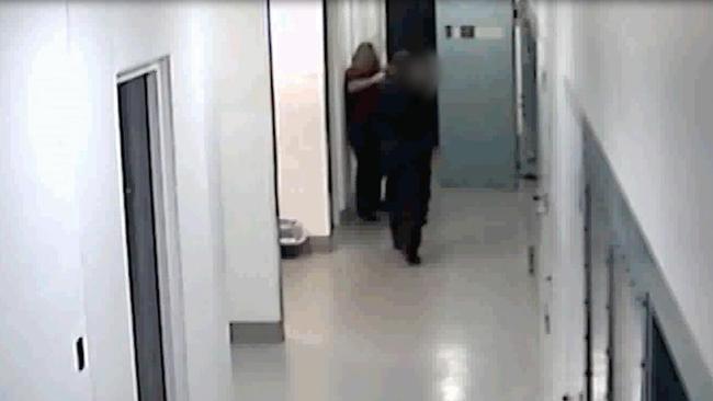 Footage shows the woman moving into a hallway where she is confronted.