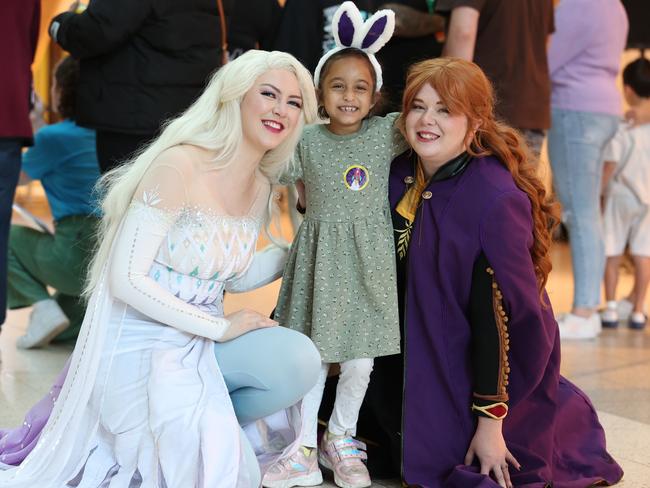 Raaya Khan, 7, with Cosplay princesses Elsa and Anna. Picture: David Caird