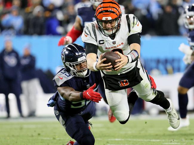 NASHVILLE, TENNESSEE - JANUARY 22: Quarterback Joe Burrow #9 of the Cincinnati Bengals dives for a third quarter first down in front of inside linebacker Jayon Brown #55 of the Tennessee Titans in the AFC Divisional Playoff game at Nissan Stadium on January 22, 2022 in Nashville, Tennessee. (Photo by Andy Lyons/Getty Images)