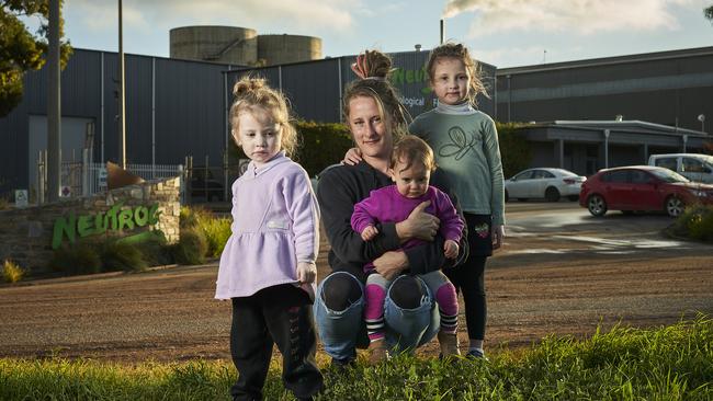 Monica Spriggs with her daughters, Storm, 3, Nova, 1, and Rivah, 5, outside Neutrog in Kanmantoo, where rotting chicken manure can be smelt. Picture: Matt Loxton