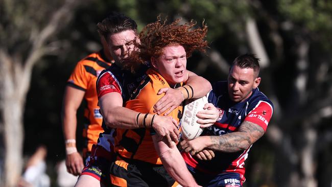 Southport Tigers lock Brock Hamill runs into the Runaway Bay defence during their Rugby League match at Bycroft oval on the Gold Coast. Photograph : Jason O'Brien