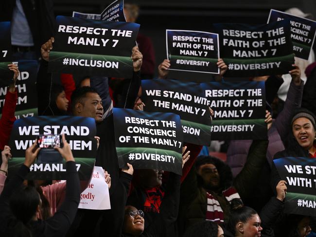 Spectators are seen holding signs in the crowd during the Round 20 NRL match between the Manly Warringah Sea Eagles and the Sydney Roosters at 4 Pines Park in Sydney, Thursday, July 28, 2022. (AAP Image/Dan Himbrechts) NO ARCHIVING, EDITORIAL USE ONLY