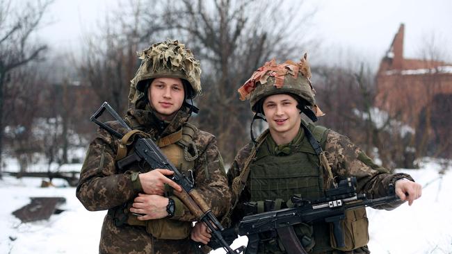 Ukrainian servicemen, brothers Vlad, 22, left, and Maxym, 20, right, on the frontline with the Russia-backed separatists near Avdiivka, Donetsk region. Picture: AFP