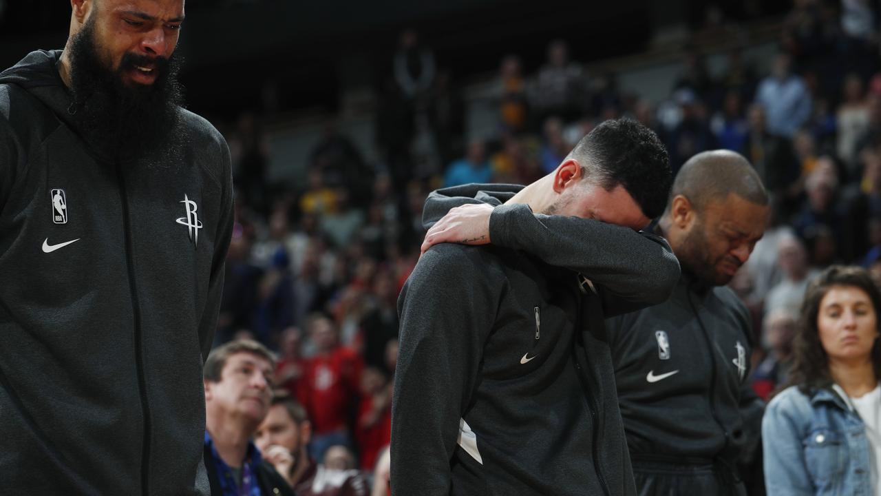 From left to right, Houston Rockets center Tyson Chandler, guard Austin Rivers and forward P.J. Tucker react during a tribute to Kobe Bryant.
