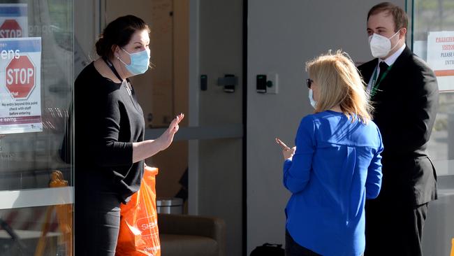 A relative of a resident at Epping Gardens Aged Care Home drops off a package. Picture: Andrew Henshaw