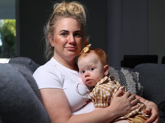 Meagan Hammond at home with daughter Lukah 1, who is battling the National Disability Insurance Scheme who have cut funding to her only treatment. Picture Lachie Millard