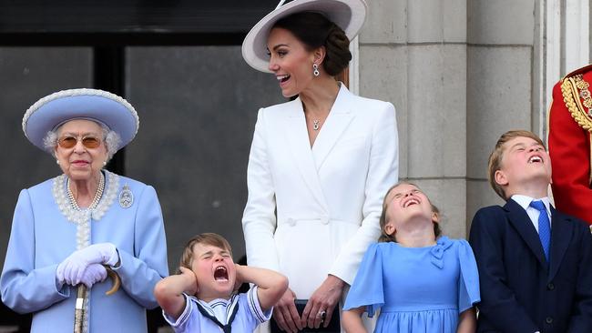 Prince Louis holds his ears as he stands next to Queen Elizabeth II, his mother the Duchess of Cambridge, sister Princess Charlotte and brother Prince George during the RAF fly-past. Picture: AFP