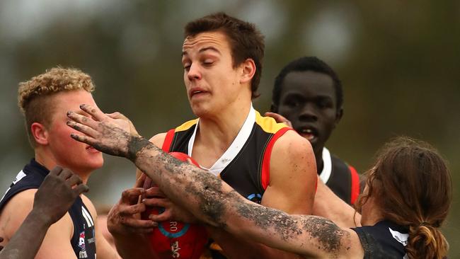 MELBOURNE, AUSTRALIA - JULY 07:  Matthew Gahan of the Stingrays is tackled during the round 11 TAC Cup match between Dandenong and Geelong at Shepley Oval on July 7, 2018 in Melbourne, Australia.  (Photo by Kelly Defina/AFL Media)