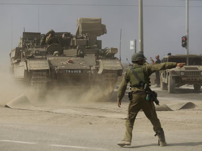 A soldier gives directions to a tank unit near the border with Gaza on October 14, 2023 near Sderot, Israel. Picture: Getty