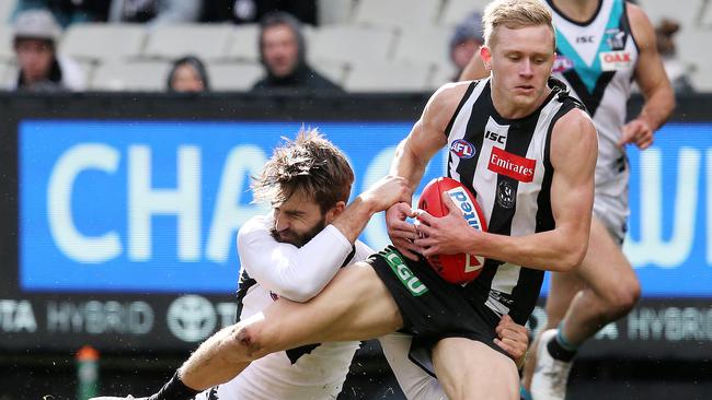 Collingwood’s Jaidyn Stephenson gets run down by Port Adelaide’s Justin Westhoff. Picture: Michael Klein