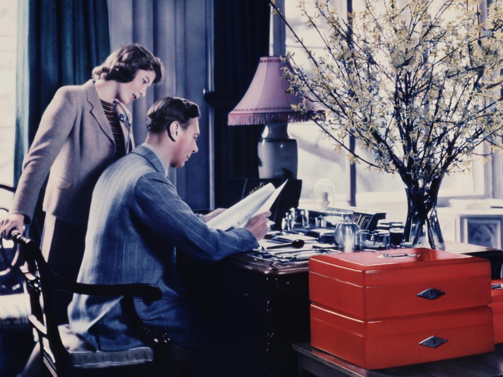 The Queen’s father goes through the royal boxes in a study at Windsor Castle. Picture: Getty