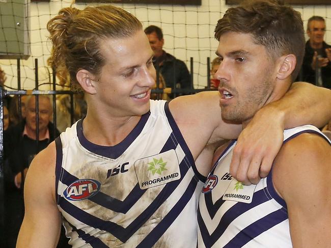 MELBOURNE, AUSTRALIA - APRIL 15:  Nat Fyfe puts his arm around Tom Sheridan of the Dockers in the rooms after the round four AFL match between the Melbourne Demons and the Fremantle Dockers at Melbourne Cricket Ground on April 15, 2017 in Melbourne, Australia.  (Photo by Darrian Traynor/Getty Images)